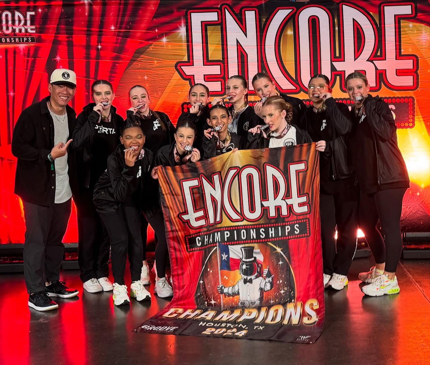 Portal Dance Lab team holding Encore Championships banner